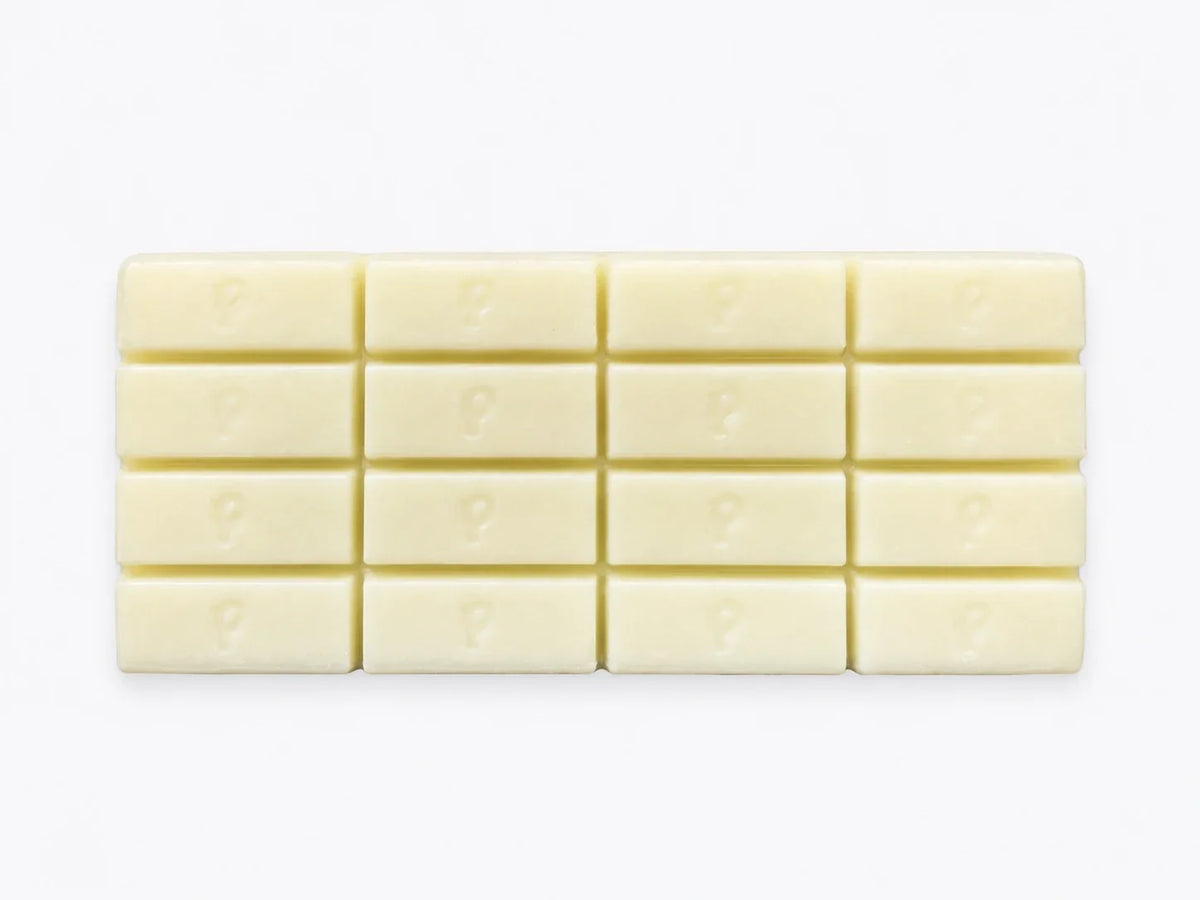 Finished custom white chocolate bar showing branded logo detail